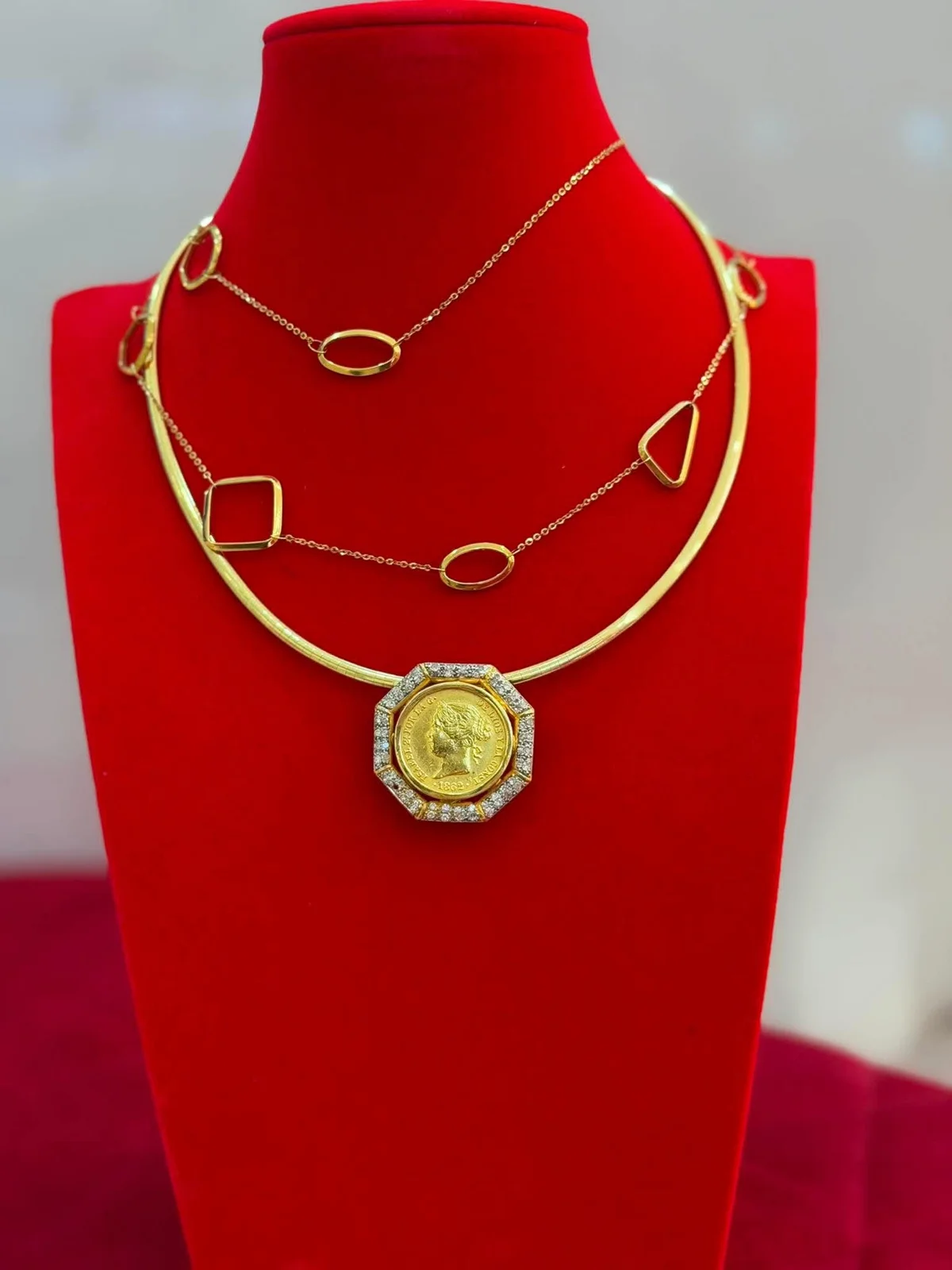 Gold chains and pendant necklaces on Jethro’s red velvet display
