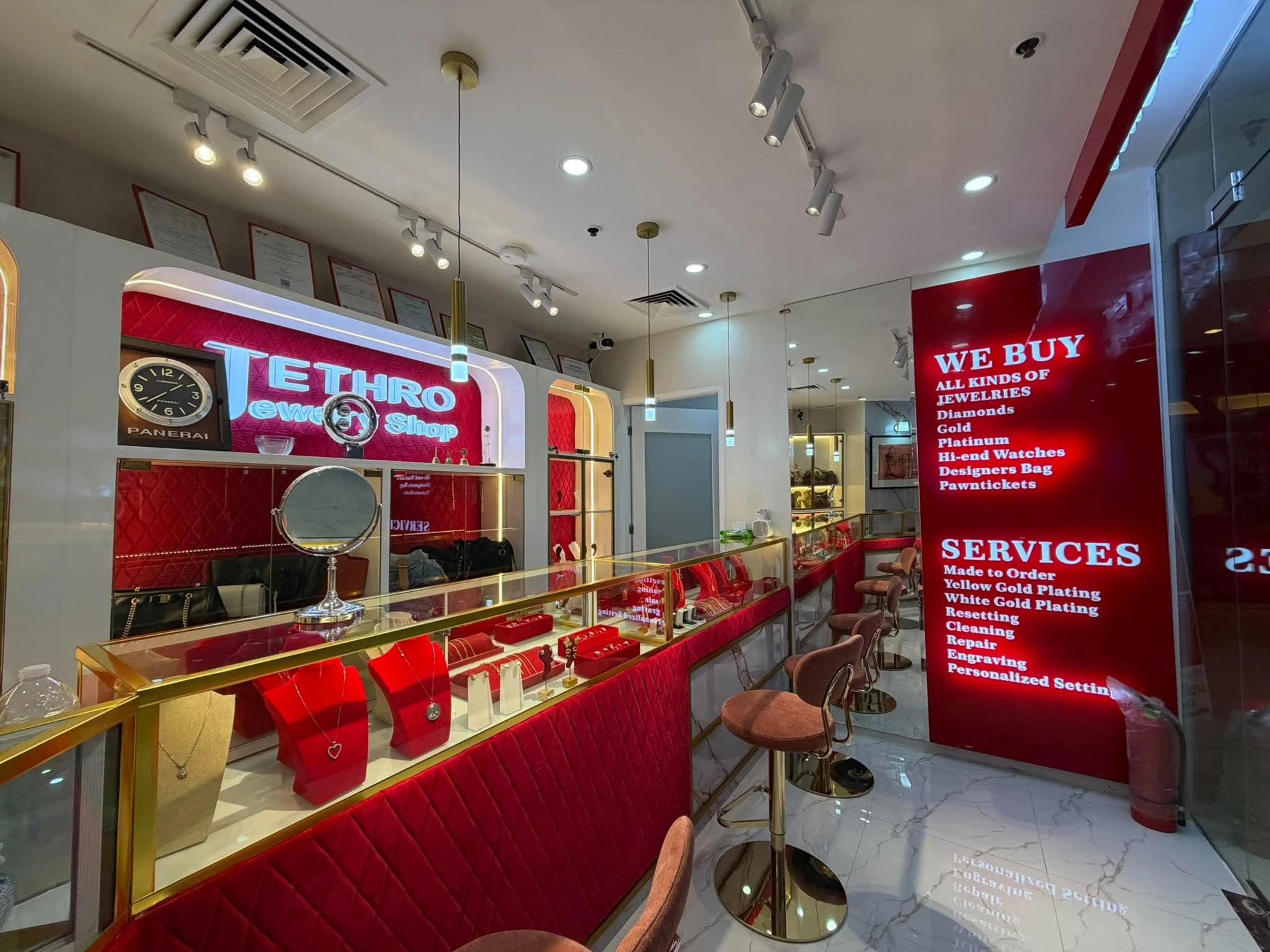 Inside Jethro Jewelry Shop, with red velvet jewelry counters and the store sign